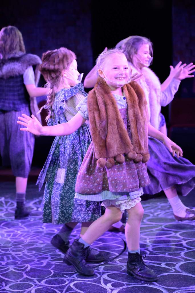 The orphans sing "Never Fully Dressed Without a Smile."