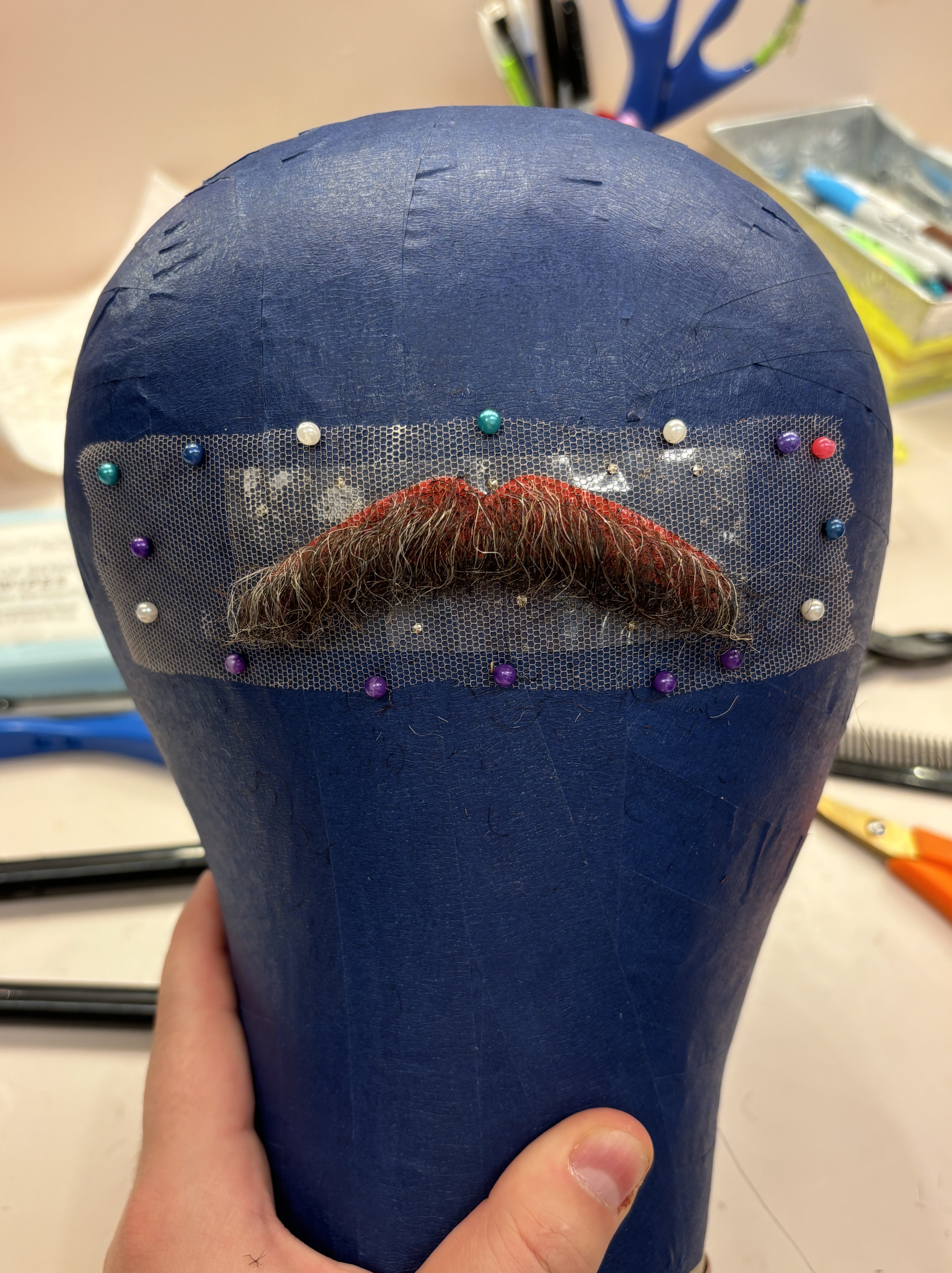 Hand-tied, cut, and styled mustache